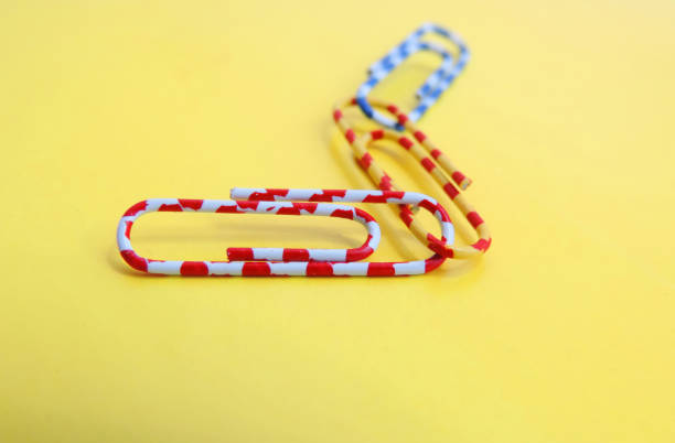 Red paper clip isolated on white background with clipping path, close up