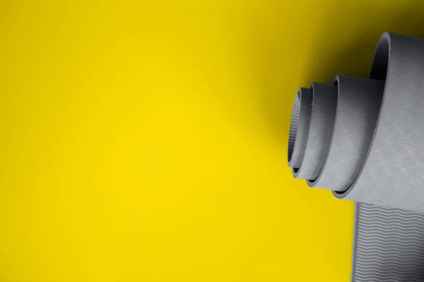 istock Ultimate gray yoga mat on a illuminating background 1290684857