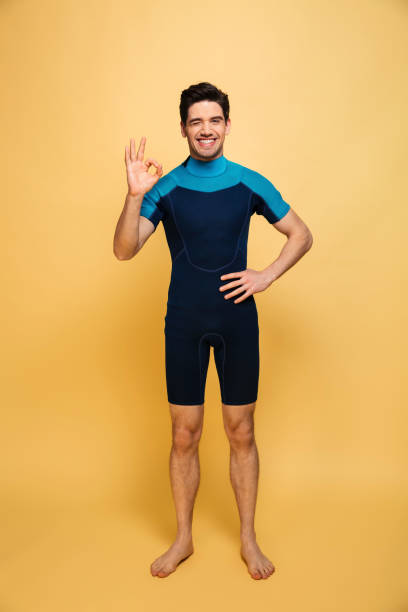 istock Happy young man dressed in swimsuit showing okay gesture. 1290687161
