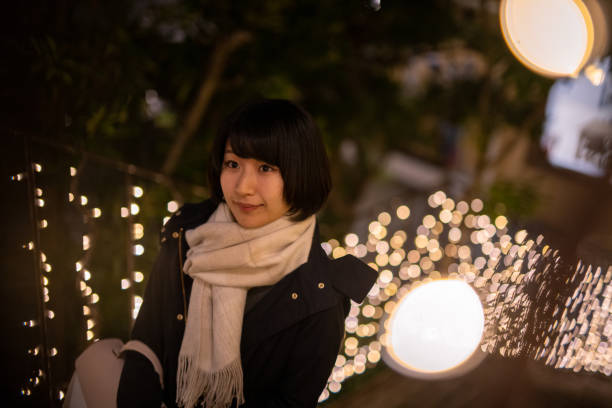 istock Young woman walking up outdoor steps at night 1290688732