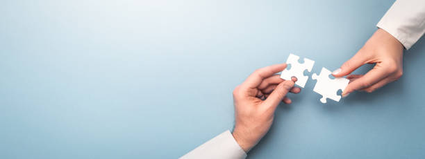 istock People holds in hand a jigsaw puzzle. Business solutions, success and strategy. 1290690779