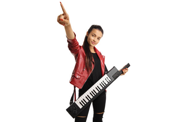 istock Young woman in a leather jacket with a keytar synthesizer pointing up 1290692114