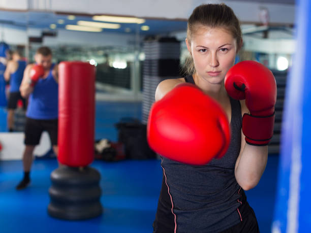 istock Woman boxing in gym 1290692391