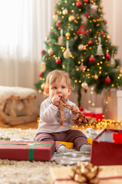 istock Baby boy playing by the Christmas tree 1290693237