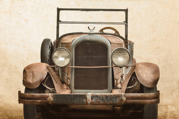 Vintage Rusted Classic Car Vintage rusted and broken classic car in front of an old wall. vintage car photos stock pictures, royalty-free photos & images