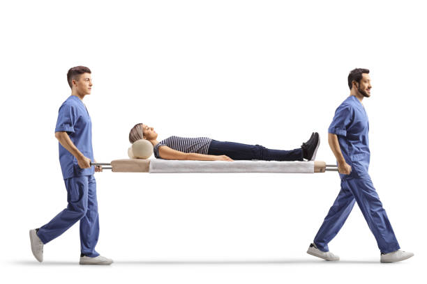 full-length-profile-shot-of-male-medical-workers-carrying-a-stretcher-with-a-female-patient.jpg