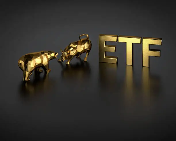 Photo of Exchange traded fund concept. A bull and bear besides the golden text ETF.