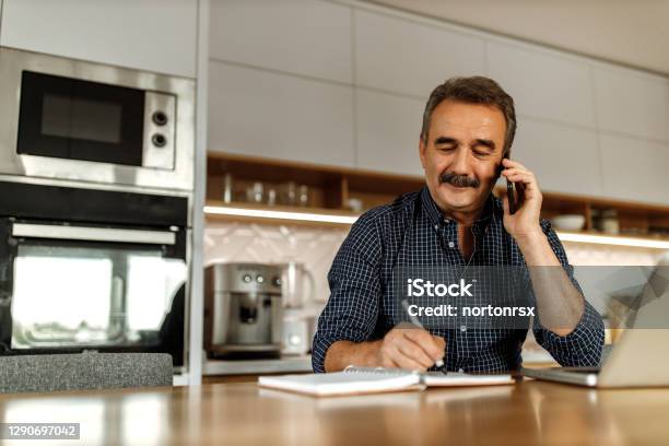 Man Talking With Someone Over The Phone Stock Photo - Download Image Now - Using Phone, Men, Writing - Activity