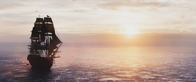 Pirate ship sailing on the ocean at sunset. Vintage cruise