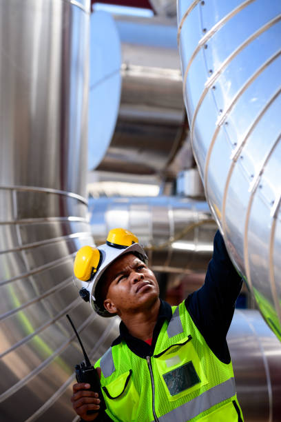 istock Solar plant worker inspecting turbine pipes 1290701834