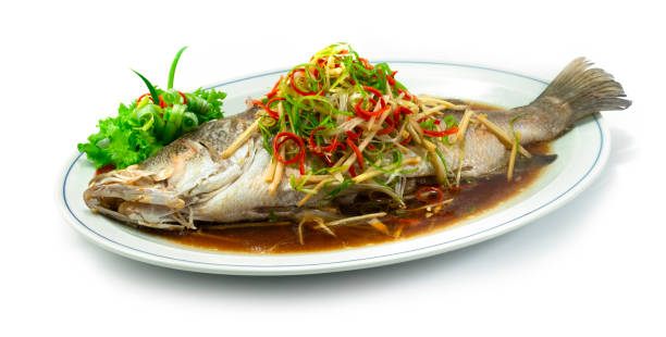 Steamed Sea bass Snapper Fish with Soy Sauce Chinese food stock photo