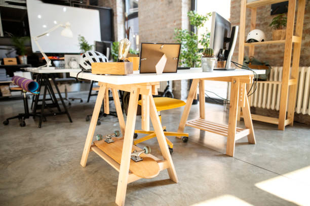 istock Wooden desk at a comfortably co-working space 1290704246