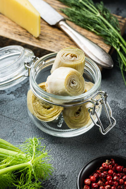 istock Pickled artichokes in oil, on  grey background 1290705513