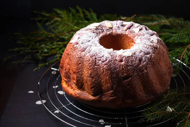 Photo of Food Concept homemade Gugelhupf, Guglhupf, Kugelhopf, kouglof bundt yeast cake of Central Europe on black background