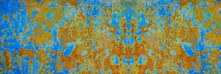 Rusty metal plate background. Orange blue abstract grunge texture background. Old rusty painted wall surface. Wide banner.