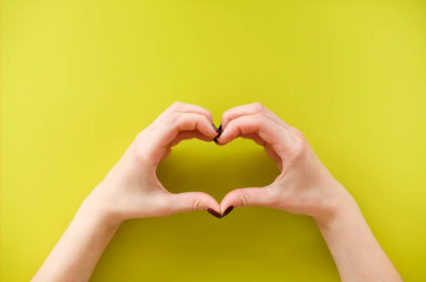 istock Woman making heart shape with hands 1290707232