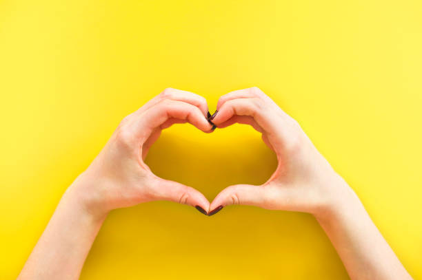 istock Woman making heart shape with hands 1290707240