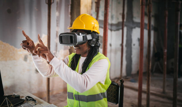 lächelnde frau mit virtual-reality-simulator auf der baustelle - surprise ideas business person pointing stock-fotos und bilder