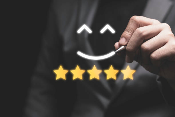 istock Customer satisfaction and product service evaluation concept , Businessman drawing smile face with yellow stars. 1290708798