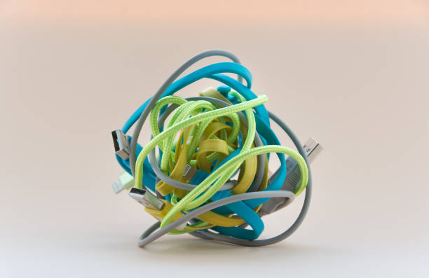 istock Tangled roll of computer wires over light background. Close-up 1290714232