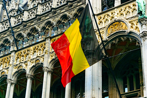 Belgian flag in the wind on the Maison du Roi (King's House) at the Grand Place in Brussels, the capital of Belgium.