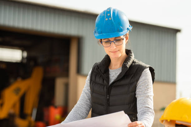 istock Female engineer going over some plans outside of a warehouse 1290717472