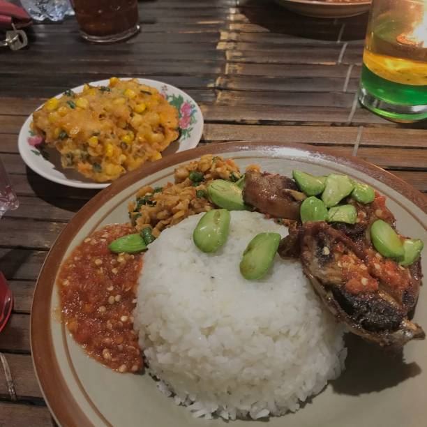 istock Lunch with rice grilled chicken stinky bean and corn fritters 1290719313