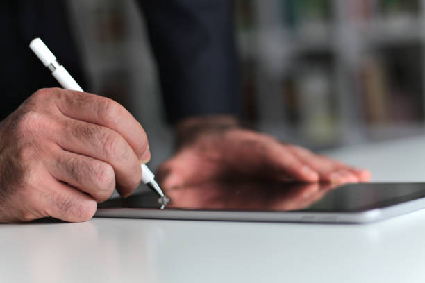 istock Digital Signature Concept with Tablet and Stylus Pen 1290719542