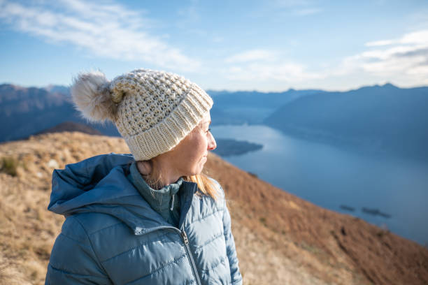 istock Hiker female contemplates view from mountain top 1290720933