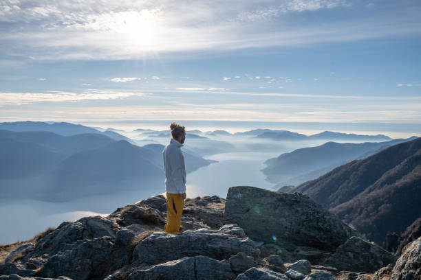 istock Hiker male contemplates view from mountain top 1290721022