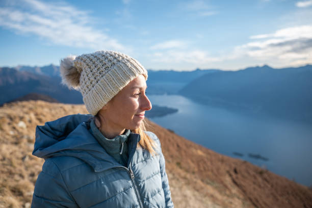 istock Hiker female contemplates view from mountain top 1290721051