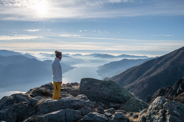 istock Hiker male contemplates view from mountain top 1290721094