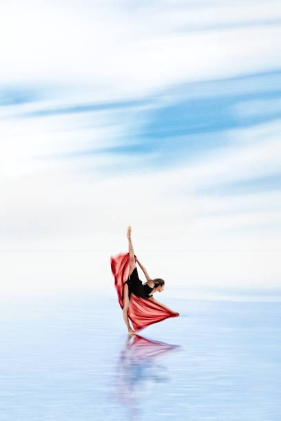 istock Ballerina dancing on the water with tulle 1290721919