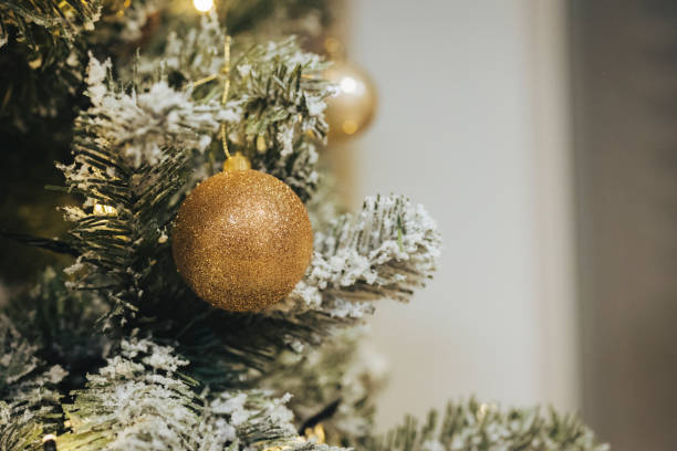 istock Golden ornament on artificial Christmas tree - Close up 1290721969