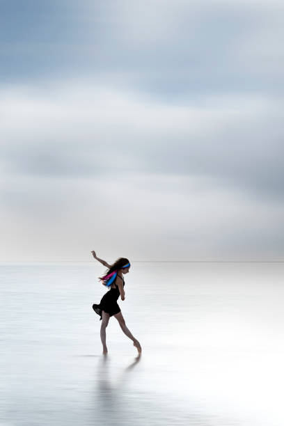 istock Ballerina dancing on the water 1290722032