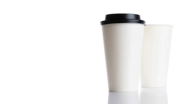 istock White paper cup for hot coffee with black lid isolated on white background. Takeaway blank small tea cup for your design text or banner of brand. 1290722105