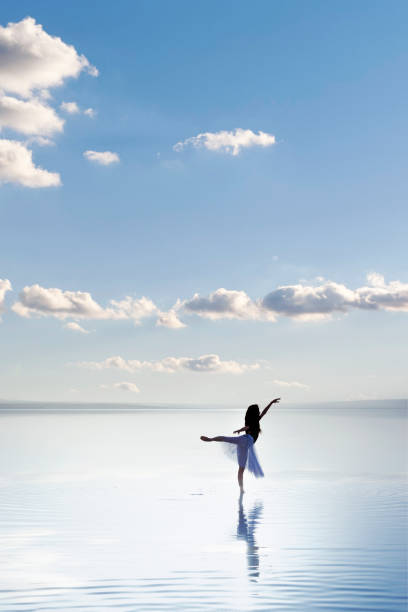 istock Ballerina dancing on the water 1290722316