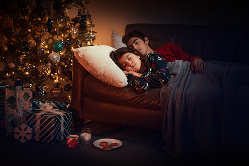 Christmas night kids sleeping in the sofa trying to catch Santa