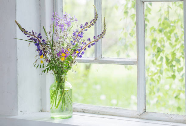 istock wild flowers in vase on white windowsill 1290723254