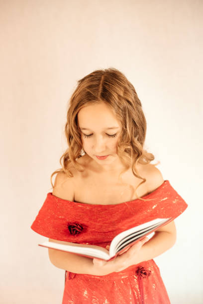 istock The child holds a book in his hands. 1290723881