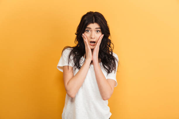 istock Shocked cute lady standing isolated looking camera. 1290724686