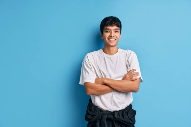 istock Happy mixed race man with crossed arms posing on blue background 1290725234