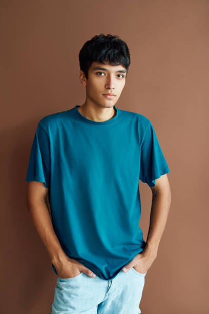 istock Young handsome mixed race man posing on studio background looking to camera 1290725250