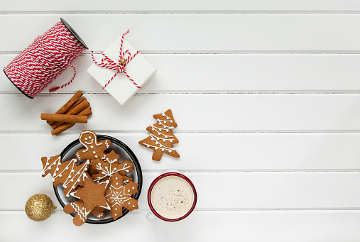 Christmas coffee and gingerbread cookies on rustic wooden table