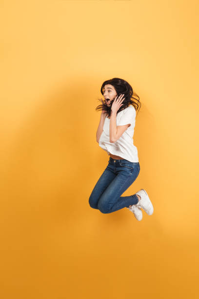istock Shocked woman jumping isolated 1290726565