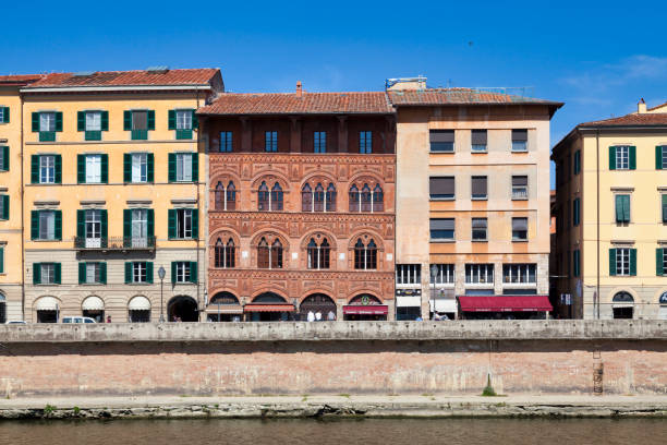 Pisa, Italy - March 31 2019: The Agostini Palace (Italian: Palazzo Agostini or Palazzo dell'Ussero or Palazzo Rosso) is one of the Renaissance palaces located on the lungarno on the right bank of the city of Pisa.