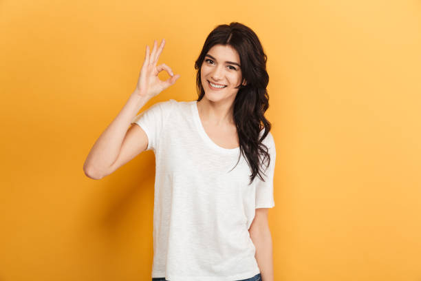 istock Cheerful young lady showing okay gesture. 1290727510