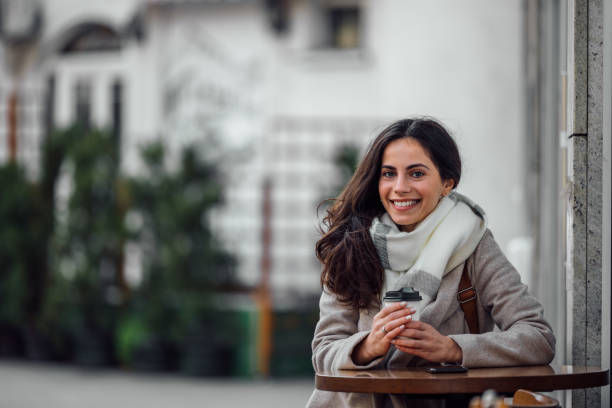 istock Wearing nude coat and white scarf. 1290727895