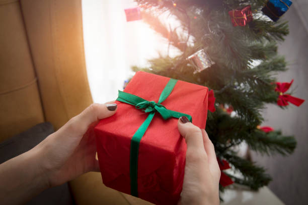 istock Close up of hands holding Christmas gift 1290729152