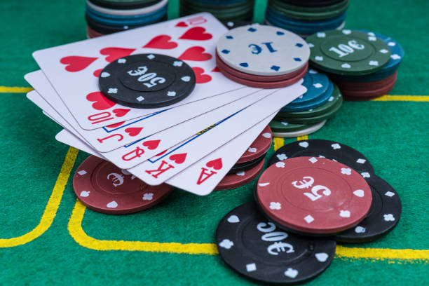 istock Cards and chips. poker royal flush on a green background. 1290729362